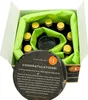 A tasting kit box with bottles and a glass inside, wrapped in green tissue paper, with a circular information card in the foreground. Produktbild-Vorschau