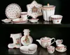 A collection of Christmas-themed ceramic tableware is displayed on a dark shelf. Náhľad obrázku produktu