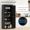 A black storage cabinet with its doors open, displaying shelves filled with various items. The background shows a kitchen counter with sinks and cabinets. Voir les images du produit