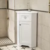 A white corner vanity cabinet with a sink and faucet is shown in a bathroom setting, next to a shower stall. Náhled obrázku produktu