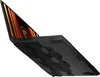 A black MSI Katana laptop is shown from a diagonal, bottom-up perspective against a white background. The laptop is open, revealing its screen which displays an abstract, fiery graphic. The bottom casing of the laptop features a distinctive hexagonal patte Produktbild-Vorschau