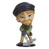 A figurine of a character with a beret, green jacket, and tan pants, holding a weapon. Produktbild-Vorschau