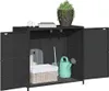 A black poly rattan garden cabinet with its doors open, displaying gardening tools and a basket inside. A potted plant sits on top. Anteprima dell’immagine prodotto
