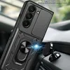A black phone case with a gold ring stand is attached to a magnetic car mount on a car dashboard. Produktbild-Vorschau