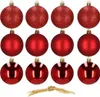 A collection of red Christmas ornaments arranged in three rows on a white background, with a piece of twine tied in a knot at the bottom. Náhled obrázku produktu