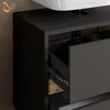 A close-up view of a modern bathroom vanity with an open drawer. Produktbild-Vorschau