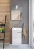 A modern bathroom vanity with a sink and faucet, a mirror above, and a towel hanging on the side. A wooden ladder shelf is on the left. Náhled obrázku produktu