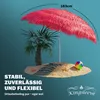 A pink straw umbrella on a miniature beach island with a palm tree and a beach ball. Produktbild-Vorschau