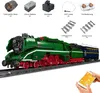 A detailed view of a green and red Lego-style train set with various components laid out above it. Voir les images du produit
