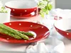A table setting with red polka dot plates and bowls, featuring asparagus and flowers. Náhľad obrázku produktu