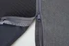 A close-up view of a zipper on a dark gray fabric product, showing the stitching and texture of the material. Produktbild-Vorschau
