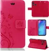 A collage of images showing a pink flip phone case with a floral and butterfly design. Produktbild-Vorschau