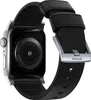 A close-up view of an Apple Watch with a black Nomad leather band, showing the back of the watch and the buckle of the band. Náhled obrázku produktu