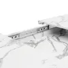 A close-up view of an extendable dining table's sliding mechanism, showing the metal rails and the marble-patterned tabletop. Podgląd zdjęcia produktu