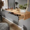 A modern vanity table with an open drawer, showcasing makeup and plants. Produktbild-Vorschau
