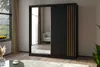A modern bedroom or living room setting with a large black wardrobe featuring a mirrored door and decorative gold accents. Produktbild-Vorschau