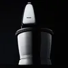 A close-up studio shot of a black hand mixer with a silver top, set against a black background. Produktbild-Vorschau