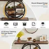 A console table with a round shelf unit and decorative items on the tabletop. Anteprima dell’immagine prodotto