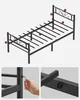 An unassembled metal bed frame with labels pointing to different parts, and two close-up shots of assembly details. Náhled obrázku produktu
