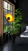 A modern bedroom scene with a floor lamp and a large plant next to a bed. Produktbild-Vorschau