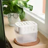 A small dehumidifier sits on a wooden windowsill next to a potted plant. Voir les images du produit