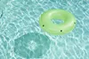 A green inflatable ring floating in a swimming pool. Náhľad obrázku produktu