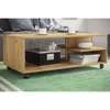 A wooden coffee table with storage, placed on a green rug in a living room setting. Podgląd zdjęcia produktu