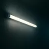 A long, white LED light fixture mounted on a dark wall. Náhľad obrázku produktu