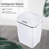 A white sensor trash can is shown in a room with a wooden floor and a blurred background. Náhľad obrázku produktu