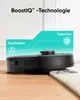 A black robot vacuum cleaner transitioning from a wooden floor to a carpet, with text overlays explaining its BoostIQ technology. Anteprima dell’immagine prodotto