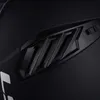 A close-up shot of a black helmet, focusing on a textured vent with the LS2 logo. Anteprima dell’immagine prodotto