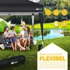 A family is enjoying a picnic under a black pop-up gazebo next to a lake, with a tent in the background. Produktbild-Vorschau