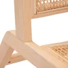 A close-up view of the wooden frame and rattan weave of a chair. Náhľad obrázku produktu
