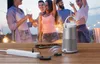 People dancing at a party with a speaker and power strip in the foreground. Produktbild-Vorschau