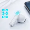A close-up of a white wireless earbud with icons indicating features like Siri, call, play/pause, voice assistant, and next track. A smartphone is visible in the background. Náhled obrázku produktu