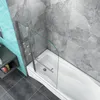 A modern bathroom with a bathtub and a glass shower screen. Produktbild-Vorschau