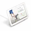 A Google Nest Hub smart display showing a commute update and a beach scene. Produktbild-Vorschau