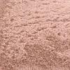 A close-up, textured view of a soft, shaggy rug. Voir les images du produit