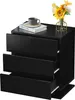 A black nightstand with three drawers, a book, a cup, and a vase of flowers on top. Produktbild-Vorschau