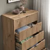 A wooden dresser with open drawers containing folded clothes. Podgląd zdjęcia produktu