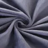 A close-up view of a soft, gray fabric, likely a pillow or blanket, with a swirling texture. Náhled obrázku produktu