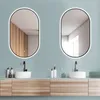 A modern bathroom vanity with two oval LED mirrors above two sinks. Produktbild-Vorschau