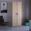 A wardrobe is shown in a room with a chair and a plant. Náhľad obrázku produktu