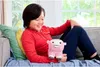 A child sitting on a couch holding a plush toy. Produktbild-Vorschau