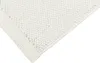 A close-up view of a cream-colored rug with a fringed edge. Anteprima dell’immagine prodotto
