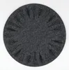 A round, dark gray felt placemat with a decorative pattern of Christmas trees and pine branches around the edge, set against a white background. Produktbild-Vorschau