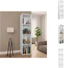 A white bookshelf filled with books and decorative items, placed in a room with a floor lamp and a sofa. Náhled obrázku produktu
