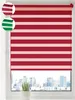 A red and white striped roller blind is shown in a window, with a cityscape visible in the background. Produktbild-Vorschau