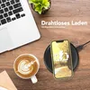 A desk scene with a laptop, coffee, and a phone charging wirelessly. Anteprima dell’immagine prodotto