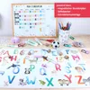 A collection of school and craft supplies arranged on a wooden surface, including a whiteboard, a desk mat with alphabet and animals, pens, pencils, and other small items. Náhled obrázku produktu